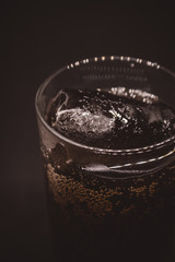 glass of water with soap bubbles on black background