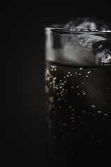 glass of water with ice on black background