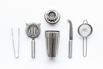 Bartender equipment set with shaker and stainer on white background top-down pattern