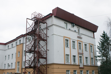 Fire Escape, red metal staircase, emergency exit on side of building 