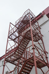 Fire Escape, red metal staircase, emergency exit on side of building 