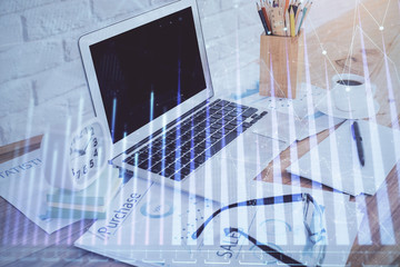 Stock market chart hologram drawn on personal computer background. Multi exposure. Concept of investment.