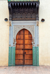 Naklejka premium Wooden door in oriental style, Fez, Morocco. Vertical.