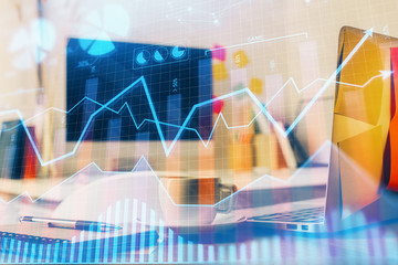 Financial graph colorful drawing and table with computer on background. Double exposure. Concept of international markets.