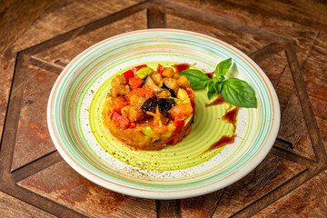 Salmon tartare with vegetables on a wooden table