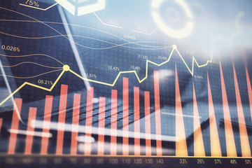 Forex market graph hologram and personal computer on background. Double exposure. Concept of investment.