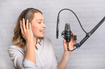Girl works on the radio or the news. Reads the news in the studio. Radio station and broadcast....