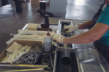 Worker works at a climatic equipment factory.