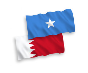 National vector fabric wave flags of Somalia and Bahrain isolated on white background. 1 to 2 proportion.