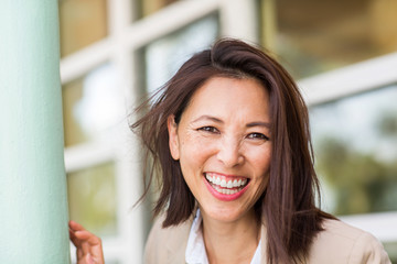Portrait of a confident Asian businesswoman smiling.