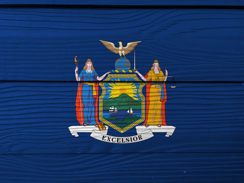 New York flag color painted on Fiber cement sheet wall background, coat of arms of the state of New York on blue field.