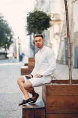 Man in a stylish clothes. Businessman in a summer city