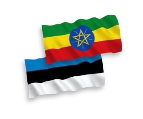 National vector fabric wave flags of Estonia and Ethiopia isolated on white background. 1 to 2 proportion.