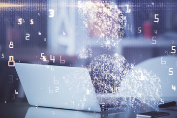 Computer on desktop in office with technology theme hologram. Multi exposure. Tech concept.