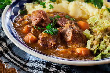 Traditional irish stew served with potatoes and cabbage