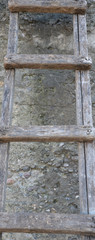 old wooden ladder in front of wall