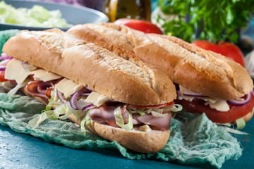 Submarine sandwiches with ham, cheese and vegetables