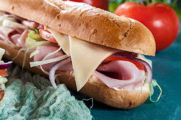 Submarine sandwiches with ham, cheese and vegetables