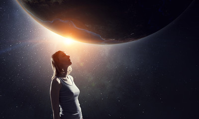 Fototapeta na wymiar Girl looking at Earth planet