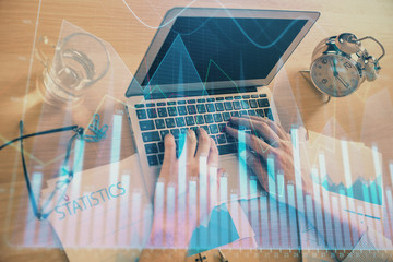 Multi exposure of forex graph with man working on computer on background. Concept of market...
