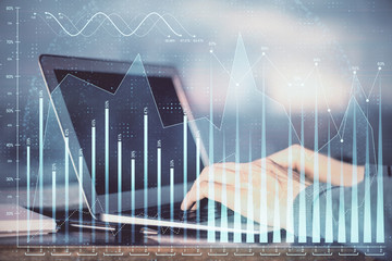 Double exposure of stock market graph with man working on laptop on background. Concept of financial analysis.