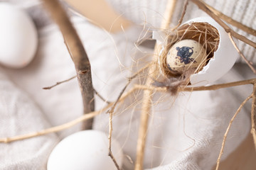 quail egg in nest made from egg in rustic beige colours monochrome. Easter holidays decoration 