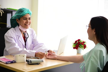 Doctor is explaining the diagnose results to patient and blood pressure meter on the table.	