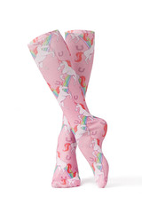 Subject shot of dense pink knee socks with childish print of unicorns and rainbows. The photo is...