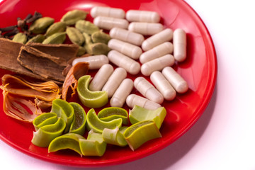 Ayurvedic medicine concept in India. Assorted whole Spices with ayurvedic drugs and sliced aloe...