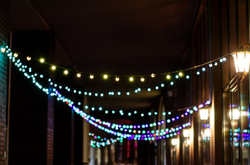 Abstract background with colored Garland light bokeh in dark. Bokeh abstract for background.
