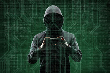 Computer hacker in mask and hoodie over abstract binary background. Obscured dark face. Data thief,...