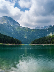 Black lake (Crno jezero) summer landscape.  Zabljak Municipality, Montenegro. People unrecognizable.