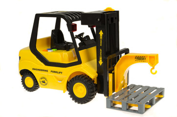 Children's  yellow toy forklift isolated on white background.