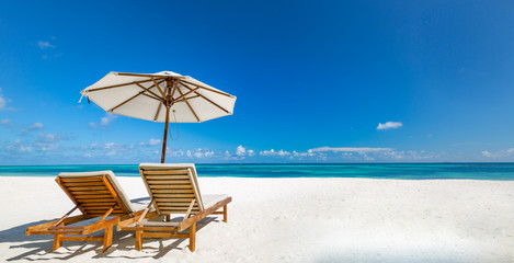 Luxury beach resort, beach loungers near the sea with white sand over sea Topical island...