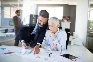 Fototapeta premium Portrait of happy business people discussing together in office