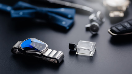 Luxury fashion men's cufflinks. Accessories for tuxedo, butterfly, tie, handkerchief, style watch and smartphone, car key isolated on the black background.