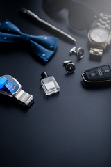 Luxury fashion men's cufflinks. Accessories for tuxedo, butterfly, tie, handkerchief, style watch and smartphone, car key isolated on the black background.