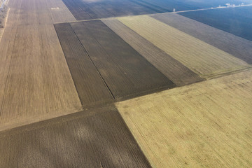 Aerial view of a country road and dry agriculture fields. Autumn winter seasonal, dry fields