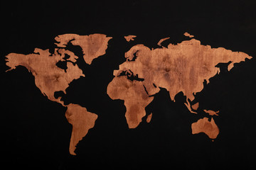 Fototapeta na wymiar World map of earth showing continents on a wood tree ring textured background
