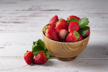 Fresh strawberries on a white wooden table