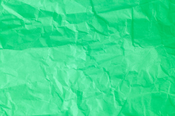 Green crumpled paper background.