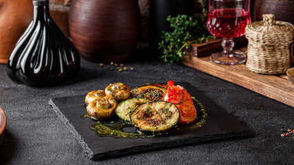 Georgian cuisine. grilled vegetables, eggplant, zucchini, champignon mushrooms, bell peppers and tomatoes. Serving dishes in a Georgian restaurant. background image, copy space