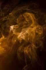 Gold smoke on black background.