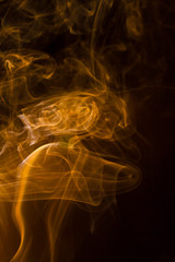 Gold smoke on black background.