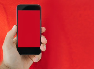 hand holding the phone with a red background In the concept of online business communication
