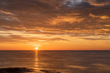 Early sunrise and epic cloudy sky at rocky seashore coast of Torrevieja, Alicante, Spain. Mediterranean sea 2019