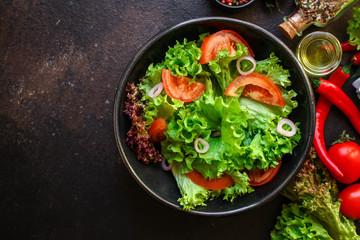 Healthy salad, leaves mix salad (mix micro greens, cucumber, tomato, chili pepper, other ingredients). food background. copy space
