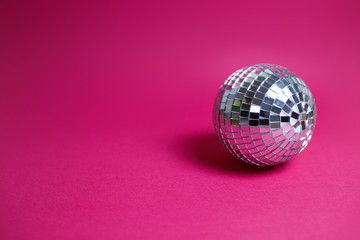 Saint Valentine's day card on pink background. Bright disco ball, colorful image, party theme.