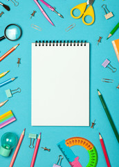 Colorful pink background with various School accessories and stationery are laid out in the form of a rainbow. Empty notebook, mock up. Flat lay top view.