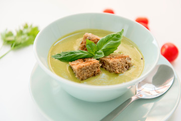 Pea cream soup on the dinner table